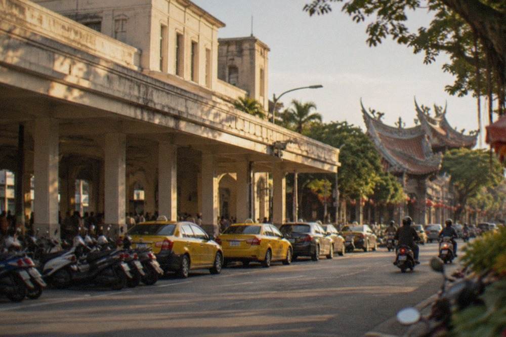 A calm Tainan street with temples and scooters in the evening light