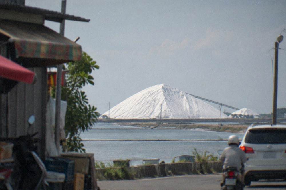 Wide view of Qigu Salt Mountain's white slopes against the Tainan coastal sky