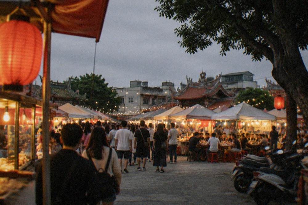 Lantern-lit night market stalls with crowds of diners in Tainan