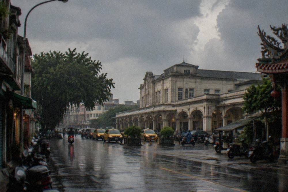 Rain falling on an empty old street with shuttered storefronts