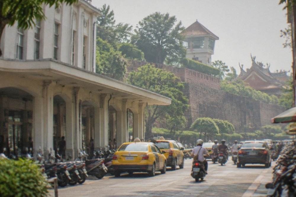 Old brick city walls and a historic watchtower surrounded by trees in Tainan