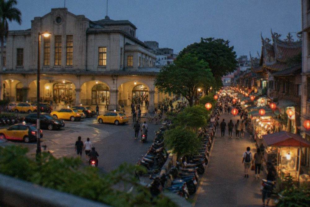A lantern-lit street in Tainan at night with food stalls and small crowds