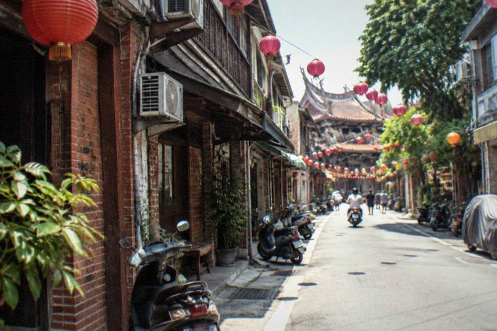 Old shop-house facades along Shennong Street lit by lanterns in the evening
