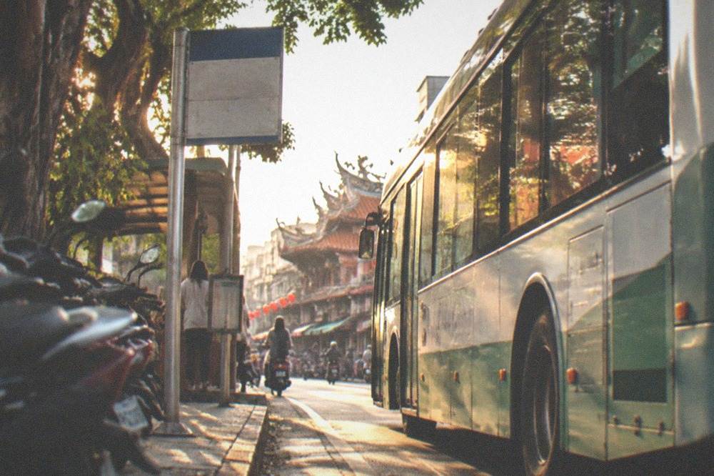 City bus stopped at a street-side stop in central Tainan