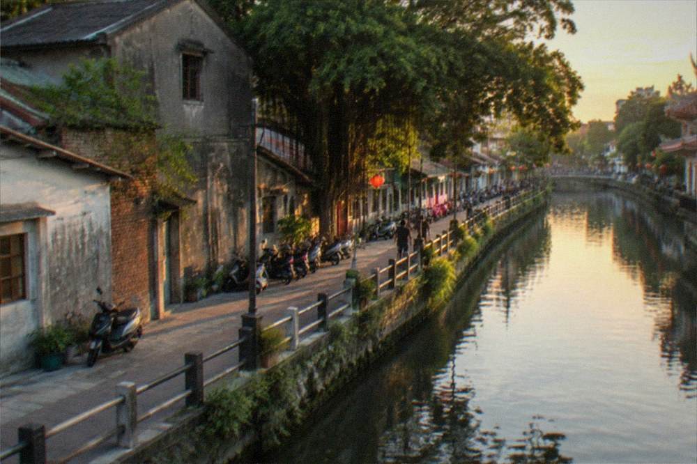 Canal-side walkway and old warehouses along the Tainan canal at dusk