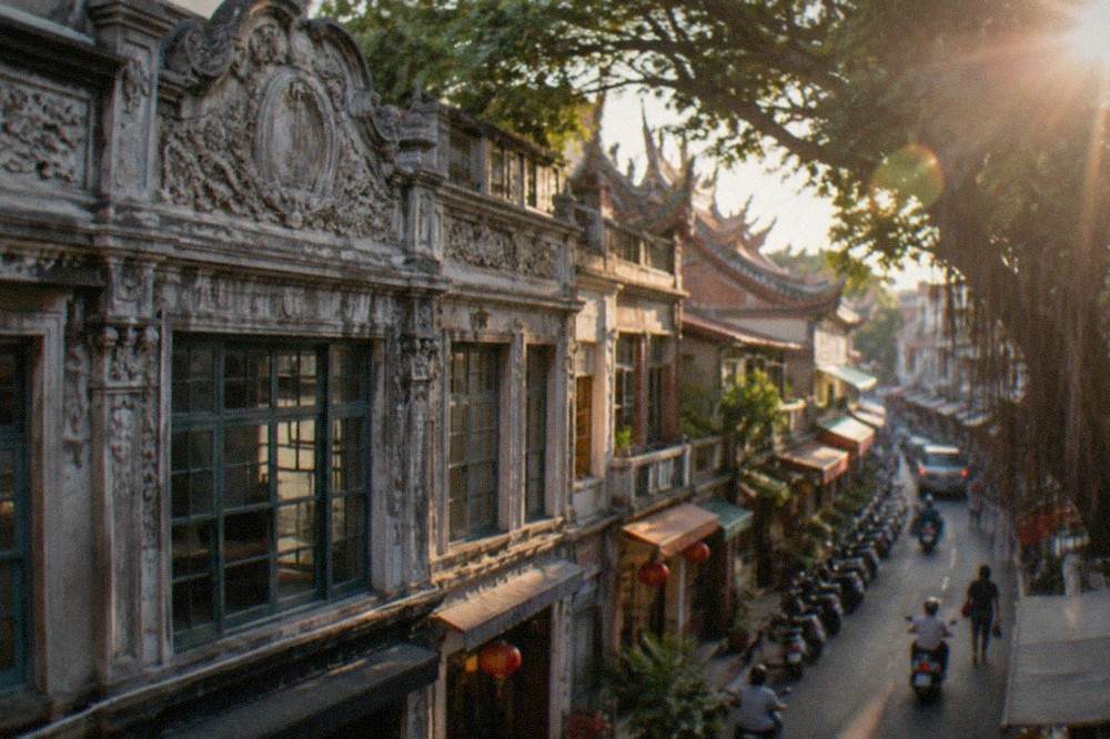 A decorated old shophouse facade with carved ornamentation above the shopfronts on Xinhua Old Street