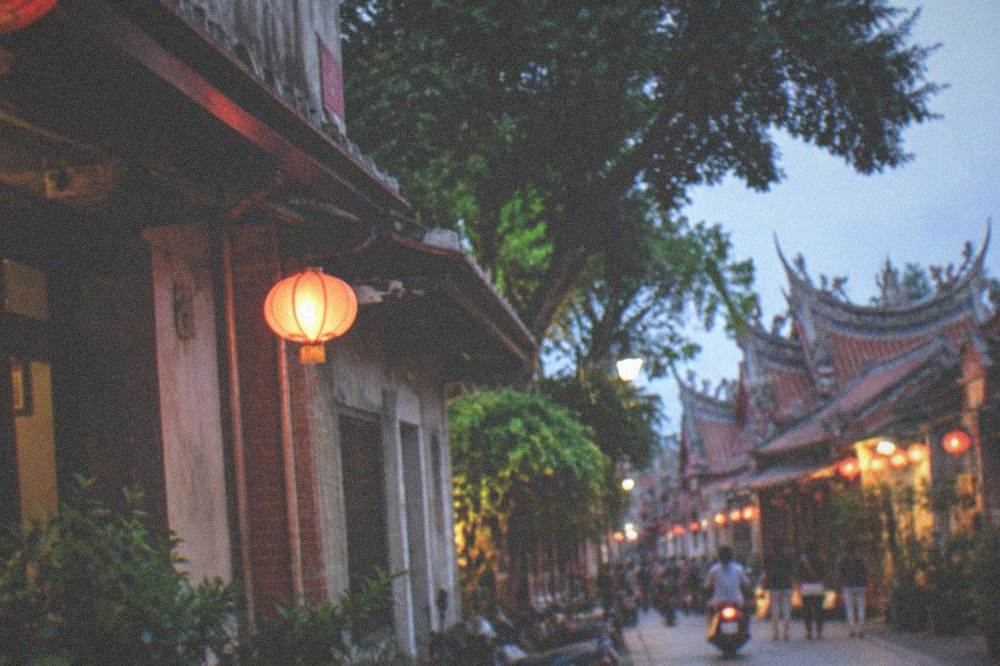 A historic street scene in warm late-afternoon light with decorative building fronts