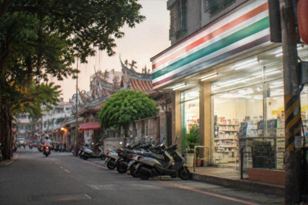 A Taiwanese convenience store glowing at night on a quiet district street