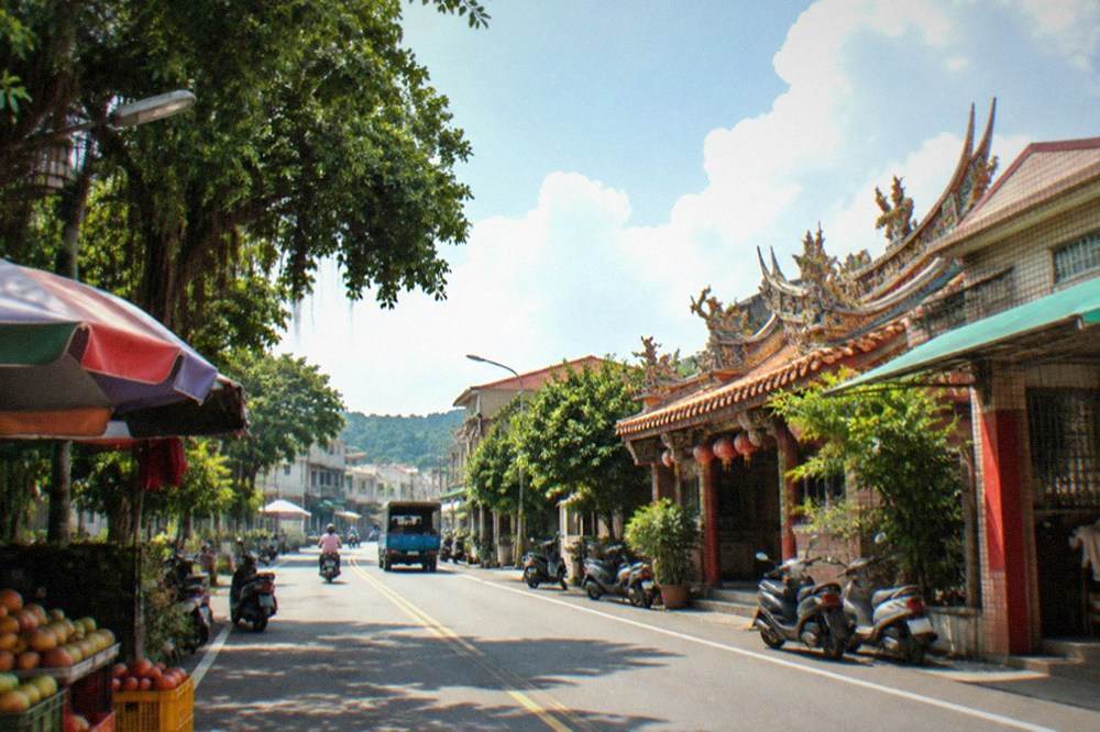 A country road winding through mango orchards in the hills of Yujing