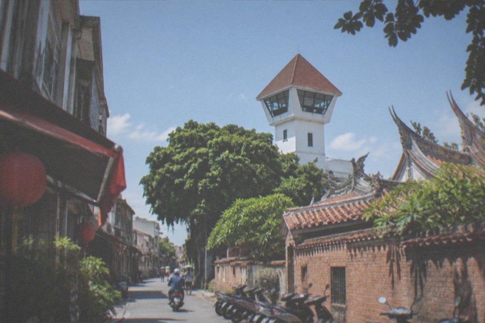 The white-walled lookout tower of Anping Old Fort seen above old rooftops