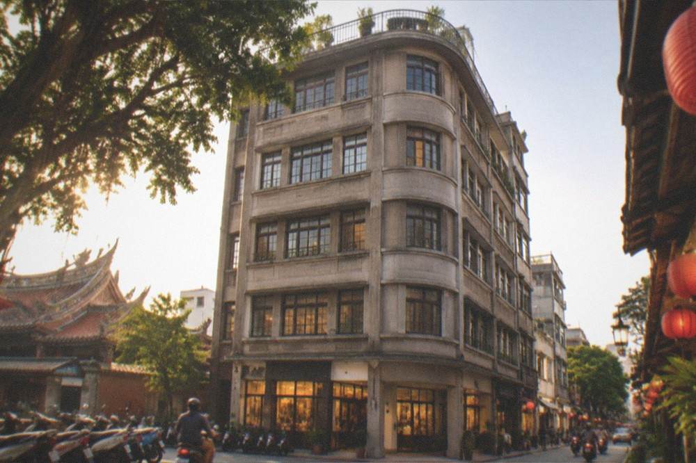 A quiet street in the old city at dusk with warm light from shop windows