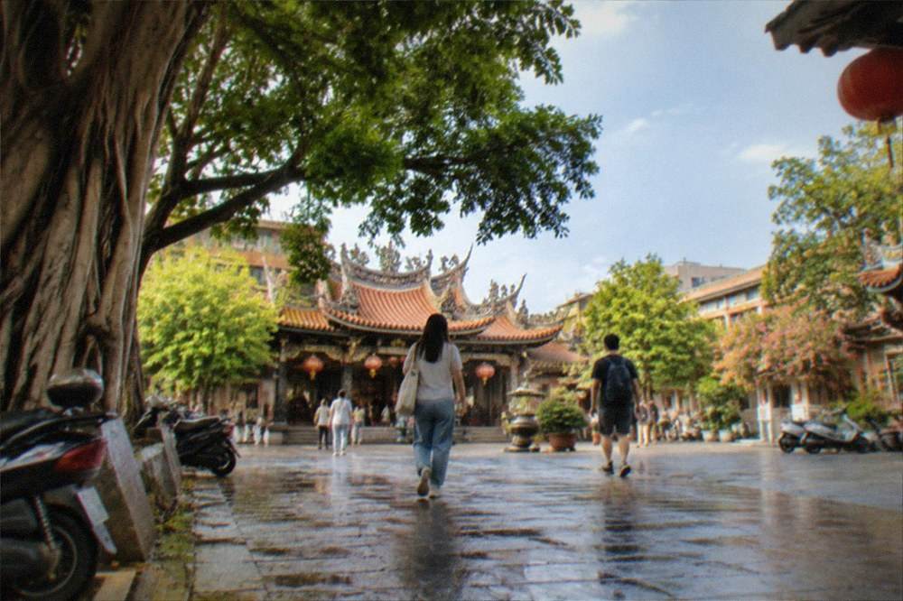 Visitors walking through a free temple courtyard in Tainan