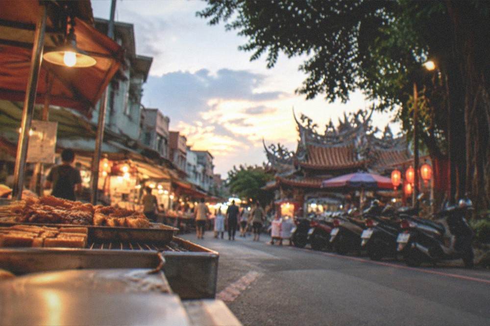Evening food stalls lighting up along a street in Anping, Tainan