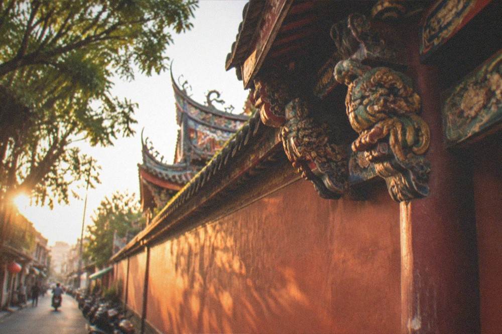 Detail of carved and painted woodwork on a historic temple facade