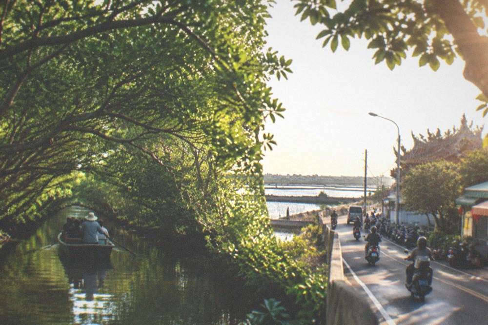 A coastal road in rural Tainan with flat wetlands and fish ponds on both sides