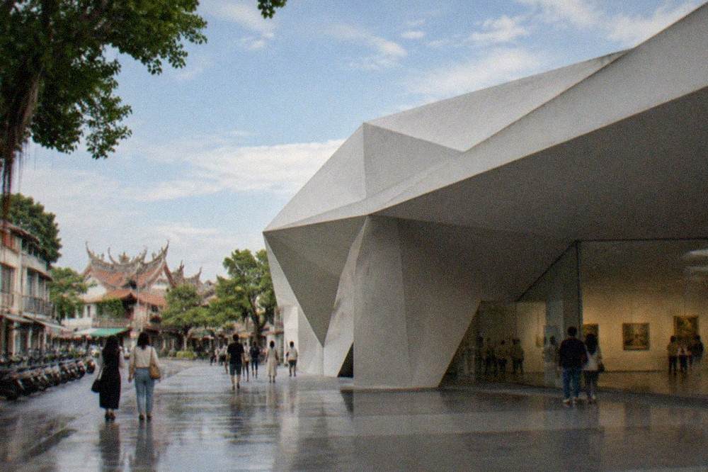 A bright museum gallery interior with paintings on white walls and visitors walking through