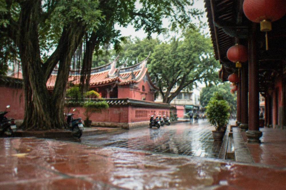 Lanterns and decorative hangings along a historic temple walkway