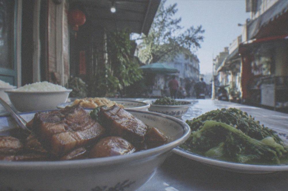 A table of Hakka dishes with stewed pork and leafy greens