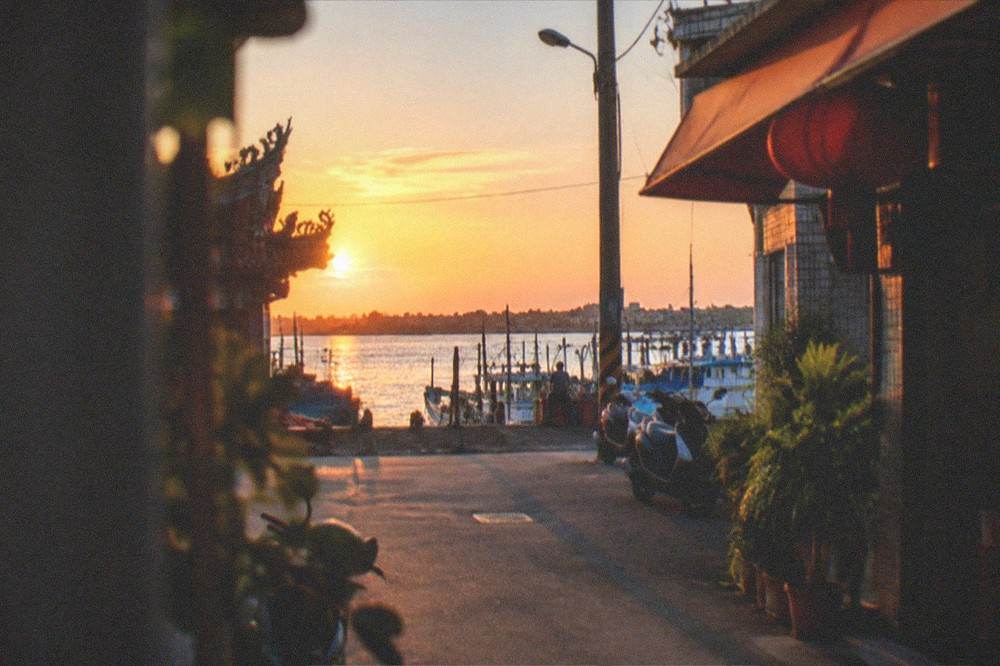 Sunset light over the lagoon water with boats moored along the Qigu shoreline