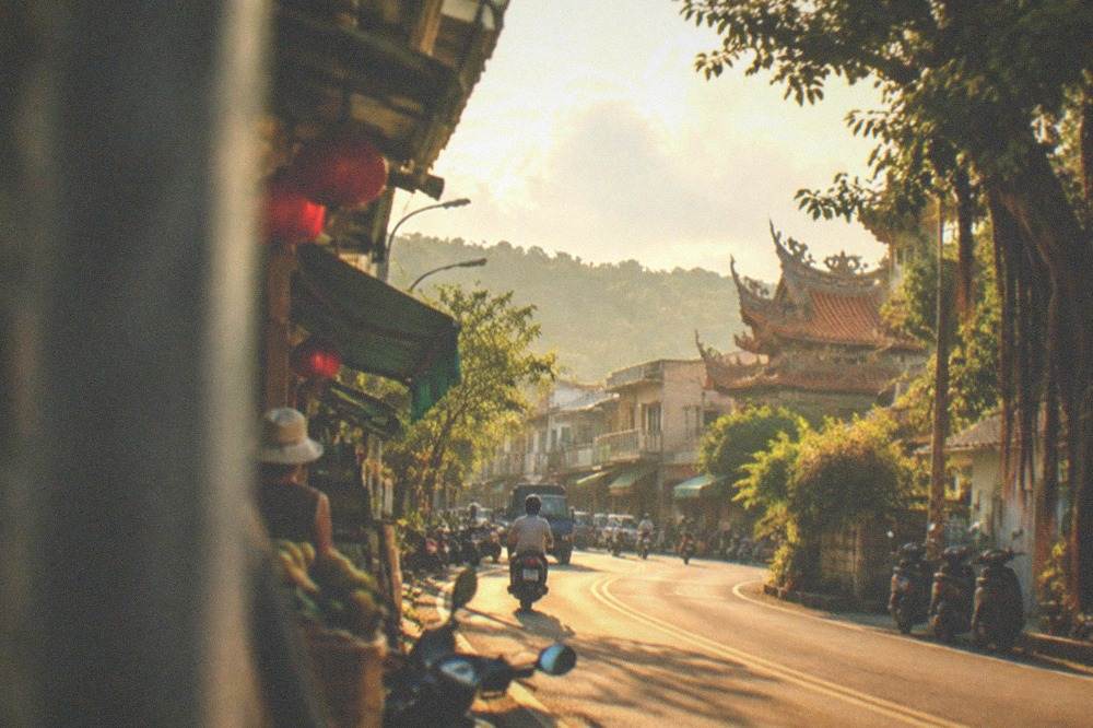 A country road winding through green hills toward Yujing district in Tainan
