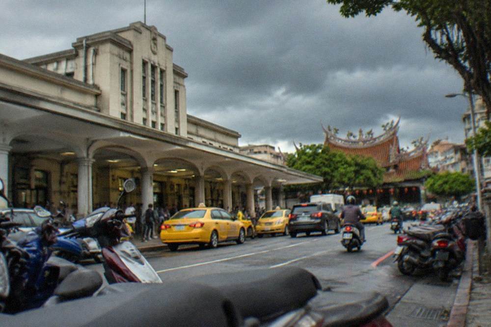 Dark storm clouds gathering over a Tainan temple roofline