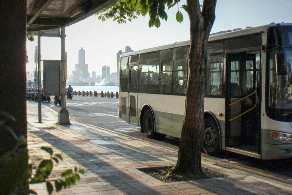 A city shuttle bus parked at a station curb in Tainan