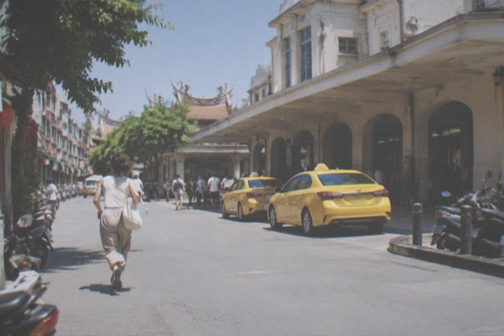 A dry sunny street in Tainan with old shopfronts and clear skies