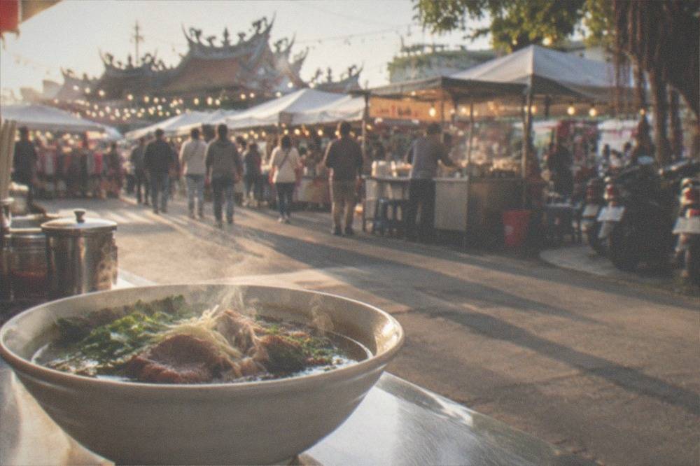 A steaming bowl of Tainan beef soup on a restaurant counter