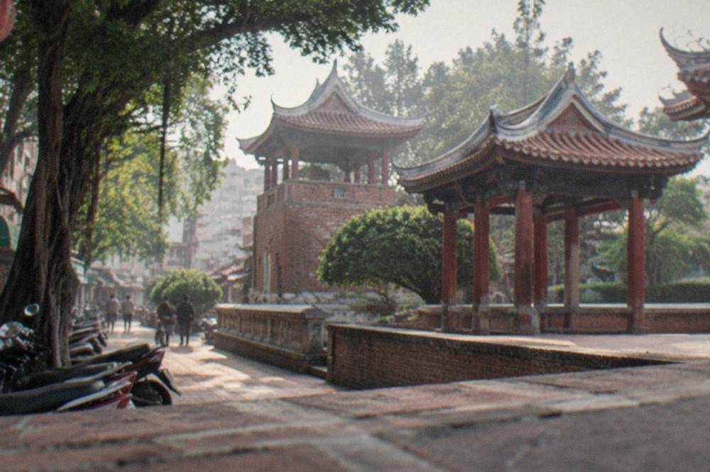 A red-brick historic tower with Chinese pavilions in a courtyard in Tainan