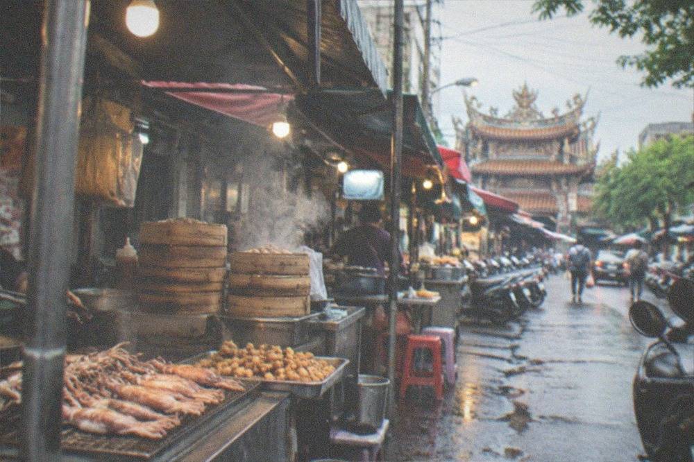 Grilled squid and fried snacks cooking at a Tainan night market stall