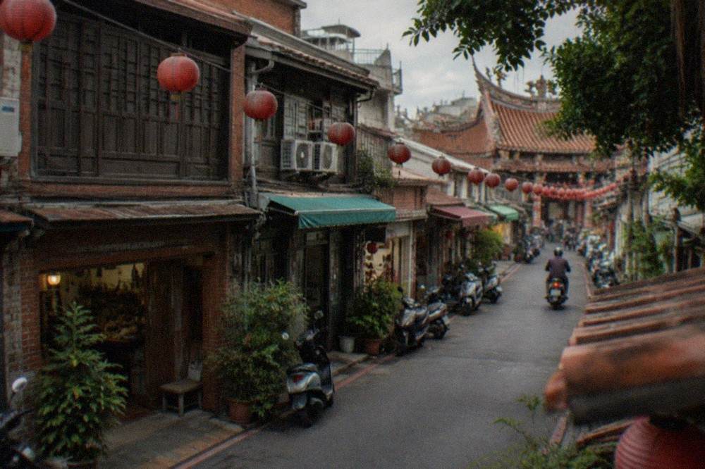 A narrow old street in Tainan with warm afternoon light on brick and tiled facades