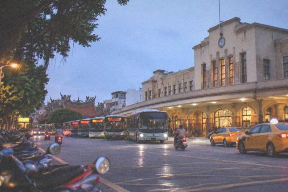 City buses lined up at the interchange plaza in front of the railway station