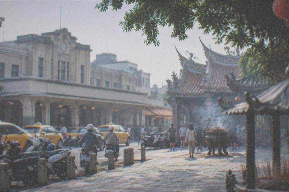A temple courtyard in Tainan with stone paving and incense smoke