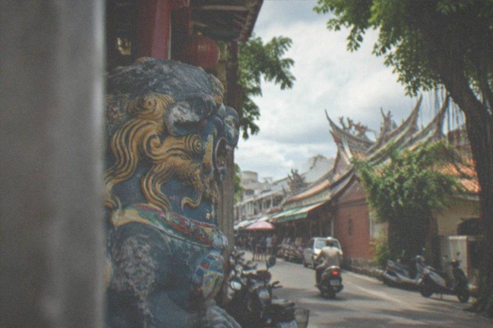 Painted sword lion plaques hanging on the wall of an Anping workshop