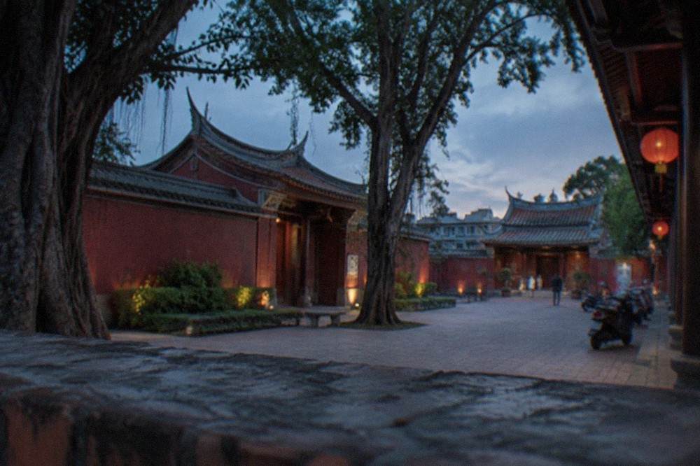 The red walls and curved roof of the Tainan Confucius Temple seen from its courtyard