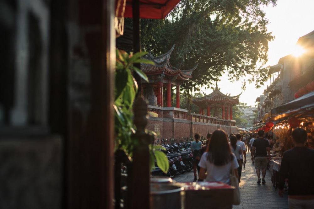Crowded night market aisles lit by rows of stall lights in Tainan