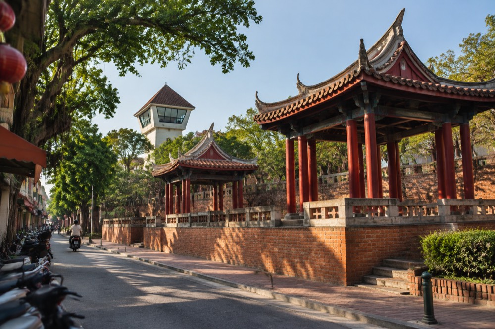 Red-brick historic walls and a lookout tower under a blue sky in Tainan