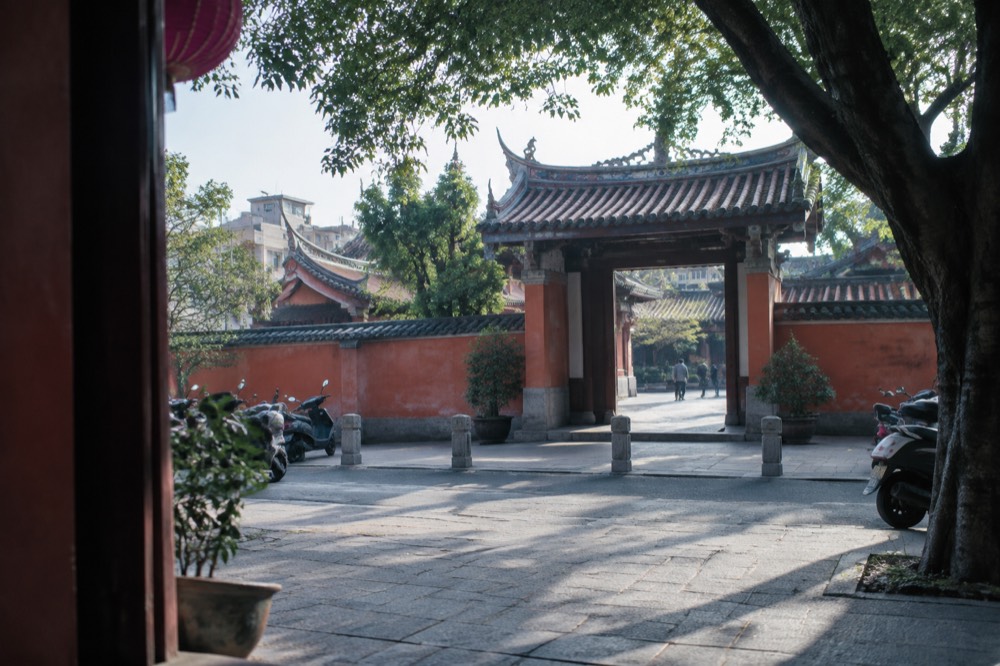 The red wall and traditional gate of the Tainan Confucius Temple with the first academy plaque